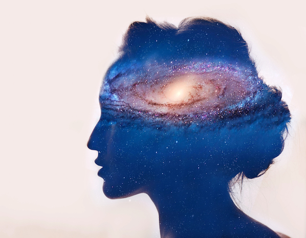 Outline of a head with a galaxy held within